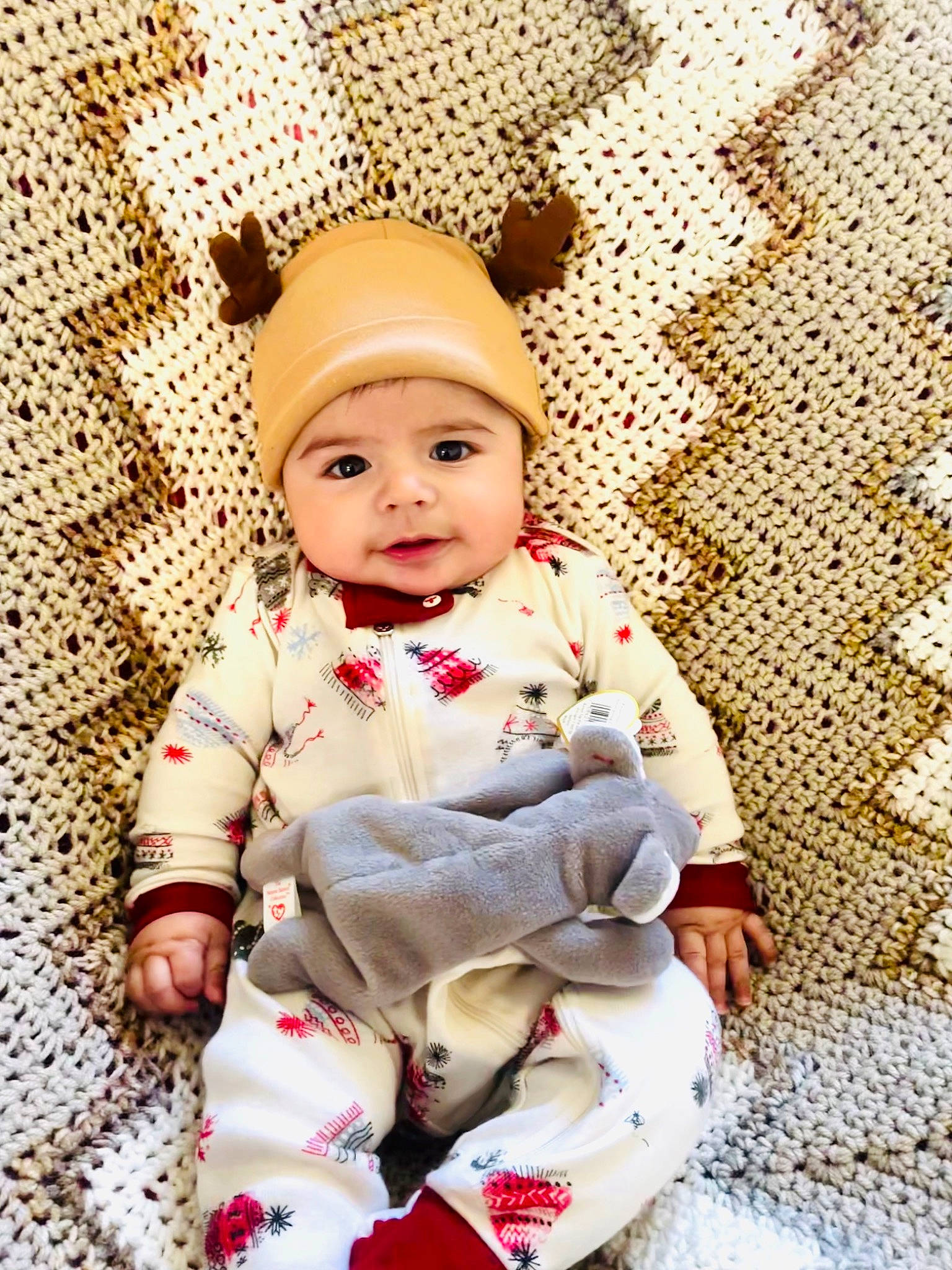 Adriel joined the competition — help win amazing prizes! baby, baby_toddler_clothing, cap, child, comfort, face, facial_expression, flooring, happy, headgear, headwear, knit_cap, linens, pattern, person, skin, sleeve, smile, textile, toddler