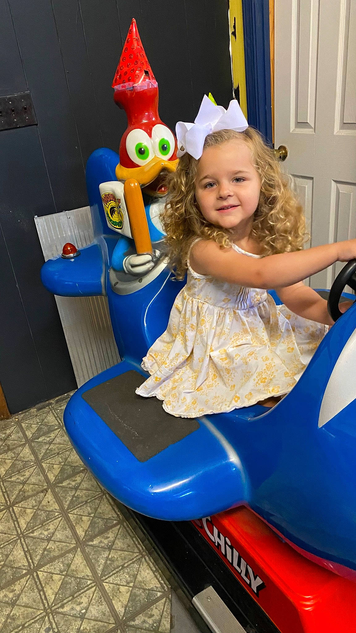 Ada Jane joined the competition — help win amazing prizes! blue, child, dress, electric_blue, event, fun, happy, human_leg, joy, leisure, party_hat, party_supply, person, play, recreation, riding_toy, room, smile, snapshot, toddler