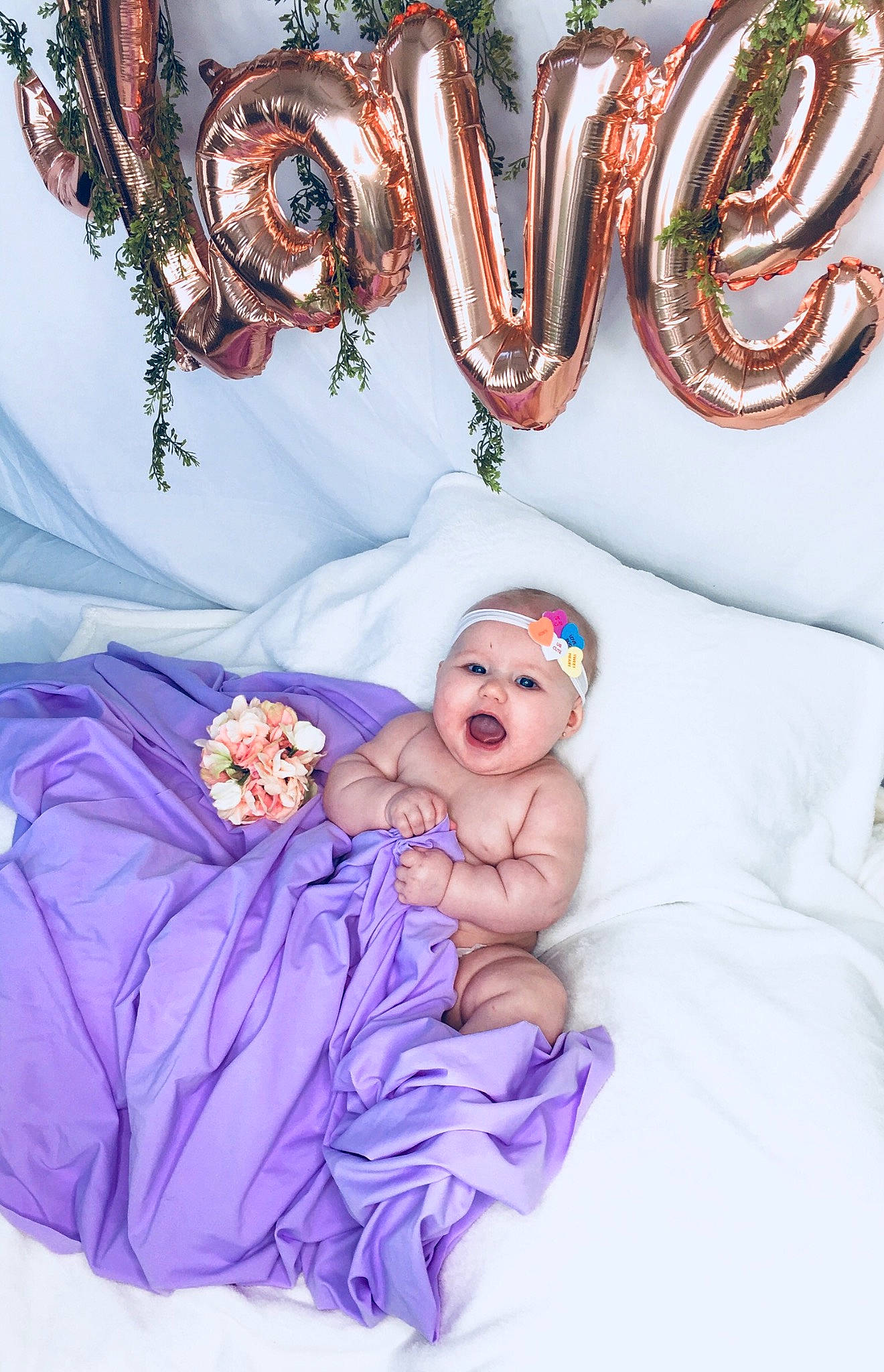 Sadie is registered to the contest to win money with this photo: baby, child, fashion_accessory, fictional_character, hair_accessory, happy, headgear, headpiece, person, photo_shoot, photograph, photography, purple, toddler, violet