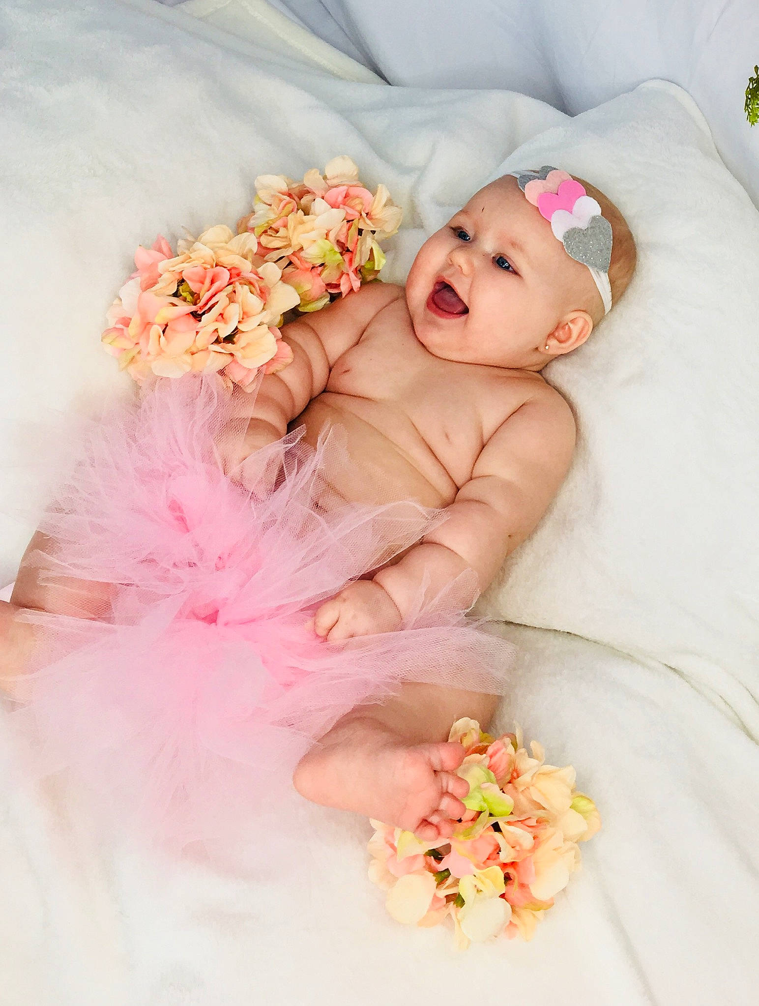 Sadie joined the competition — help win amazing prizes! baby, baby_sleeping, baby_toddler_clothing, child, dress, fashion_accessory, flower, hair_accessory, headgear, headpiece, peach, person, petal, photograph, photography, pink, plant, product, skin, textile