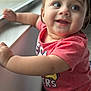 toddler, child, smiling, red_shirt, window, curious, happy, indoor, portrait, face, arm, skin, hair, baby, expression, light, daylight, casual_clothing, person, closeup