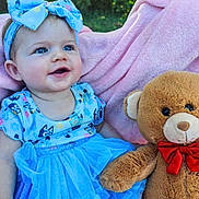 Dahlia joined the competition — help win amazing prizes! baby, child, blue_dress, blue_bow, teddy_bear, pink_blanket, outdoor, greenery, sunlight, smiling, cute, infant, happy, soft_toy, sitting, portrait, summer, headband, plush, person