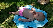 Layla joined the competition — help win amazing prizes! baby, blanket, blue, child, cute, daylight, diaper, face, grass, hand, infant, lying, nature, outdoor, pink, relaxing, shadow, skin, summer, sunlight