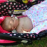 baby, infant, car_seat, pacifier, sleeping, blanket, heart_pattern, polka_dots, outdoor, grass, child, cute, resting, infant_clothing, pink, black, white, head, face, peaceful