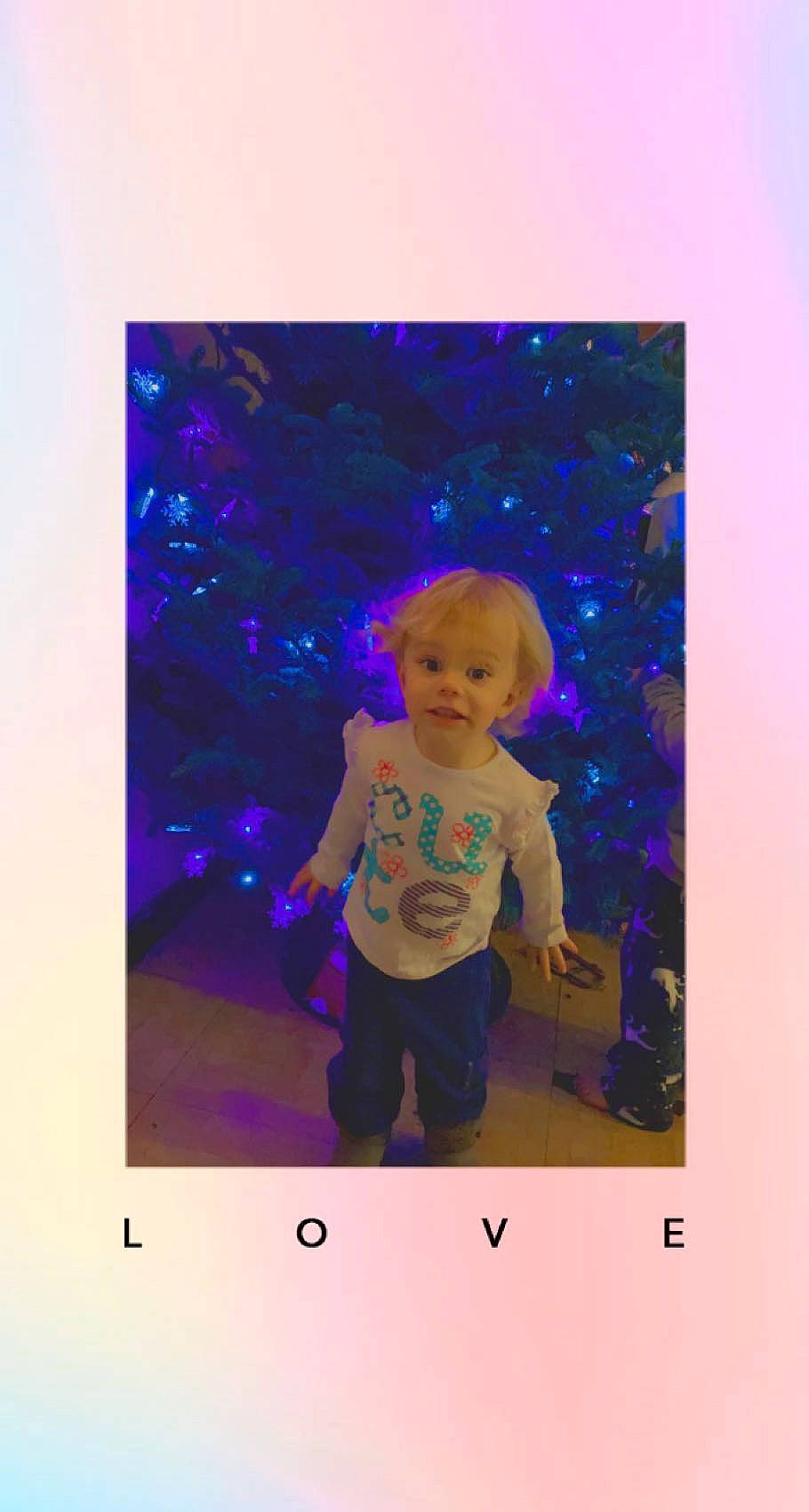Emma Rose is registered to the contest to win money with this photo: baby, child, display_device, electric_blue, font, fun, gesture, happy, magenta, person, play, purple, rectangle, room, sleeve, t_shirt, toddler, tree, violet, visual_arts