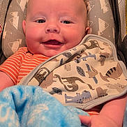 Hayden joined the competition — help win amazing prizes! baby, smiling, blanket, car_seat, bib, infant, happy, child, cute, clothing, pattern, comfort, portrait, indoor, closeup, person, head, face, baby_boy, blue