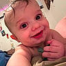 Ryder is registered to the contest to win money with this photo: baby, infant, child, smiling, happy, close_up, portrait, face, eyes, blond_hair, bare_shoulders, hands, toy, green_toy, indoor, bedroom, cozy, colorful_lights, home, photography