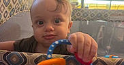 Ryder joined the competition — help win amazing prizes! baby, baby_gear, child, colorful_toy, curious, eyes, face, gripping, home, indoors, infant, nursery, patterned_fabric, photography, playpen, playtime, portrait, rattle, seated, toy