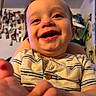 baby, infant, child, smiling, laughing, face, portrait, close_up, indoors, home, striped_shirt, clothing, reaching, hand, eyes, mouth, happy, sitting, photography, background