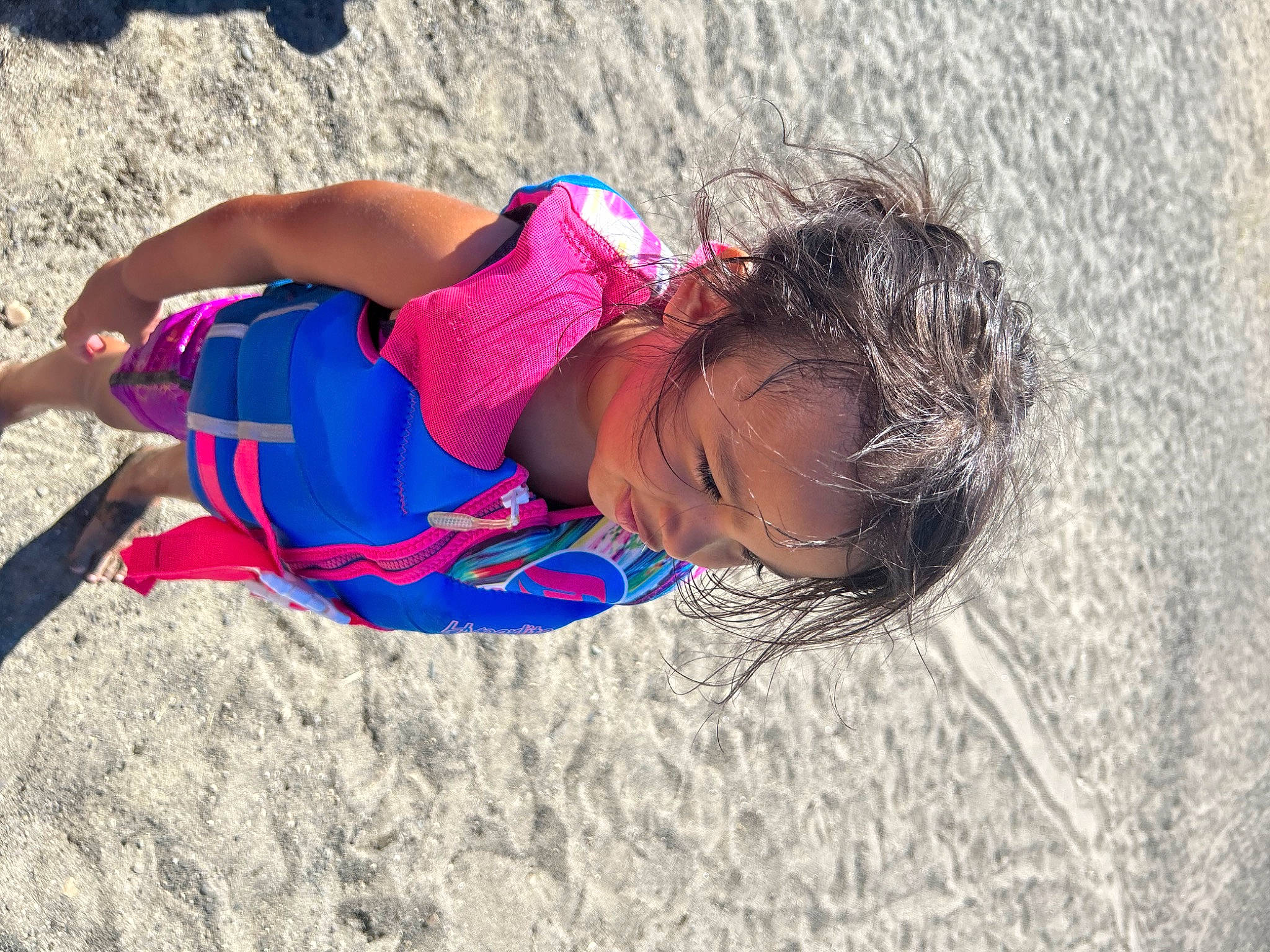 Lilah is registered to the contest to win money with this photo: beach, child, coast, electric_blue, fun, happy, human_leg, landscape, leisure, people_in_nature, people_on_beach, person, play, recreation, sand, sitting, soil, thigh, toddler, travel