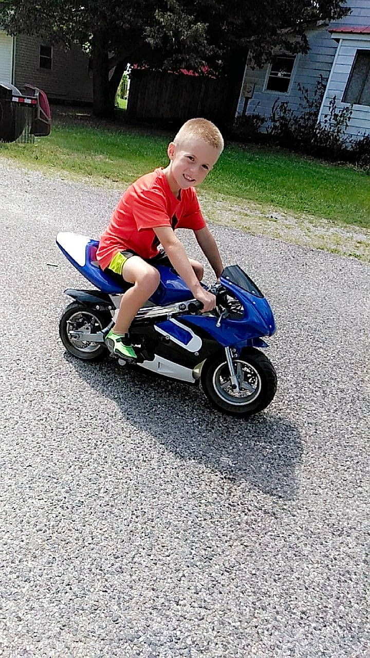 Fisher is registered to the contest to win money with this photo: auto_part, automotive_tire, automotive_wheel_system, bicycle_accessory, child, joy, person, recreation, riding_toy, toddler, tricycle, vehicle, wheel