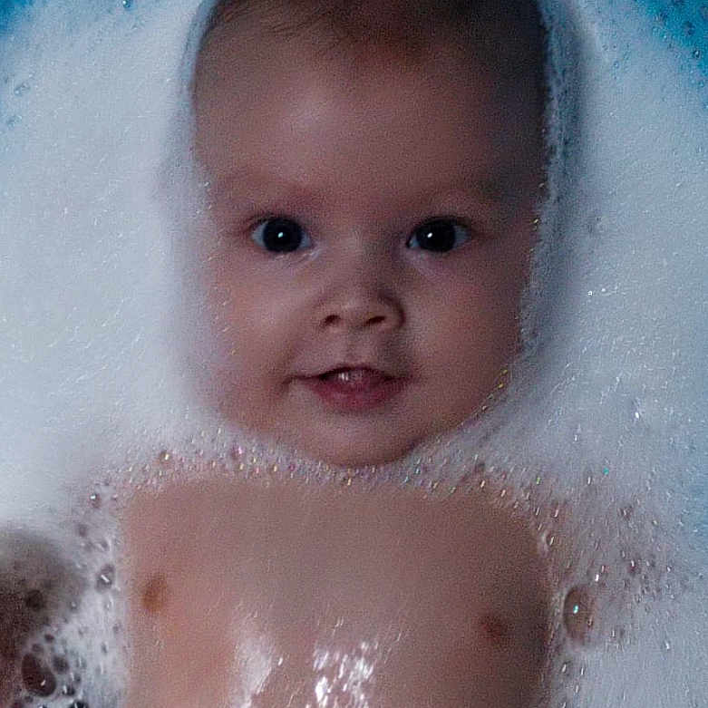 Paul is registered to the contest to win money with this photo: baby, bathing, bathroom, bathtub, bubble, face, foam, happy, head, indoors, newborn, person, photography, portrait, room, smile, tub, washing