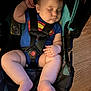 baby, sleeping, car_seat, blue_onesie, superman_logo, chubby_legs, infant, child, indoor, wooden_floor, safety_harness, peaceful, cute, portrait, childcare, resting, baby_fashion, toddler, seat, comfort