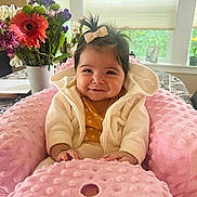 Isabella joined the competition — help win amazing prizes! baby, smile, pink_cushion, bow, hair, flower_vase, flowers, window, table, indoor, child, cute, happy, infant, clothing, jacket, bracelet, portrait, cozy, home