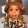 Meyron participe au concours pour gagner de l'argent avec cette photo : animal_print, baby_items, bed, bucket_hat, child, clothing, colorful, cute, drool, happy, hat, indoor, lamp, lion_king, person, portrait, smiling, sweater, toddler, young_child