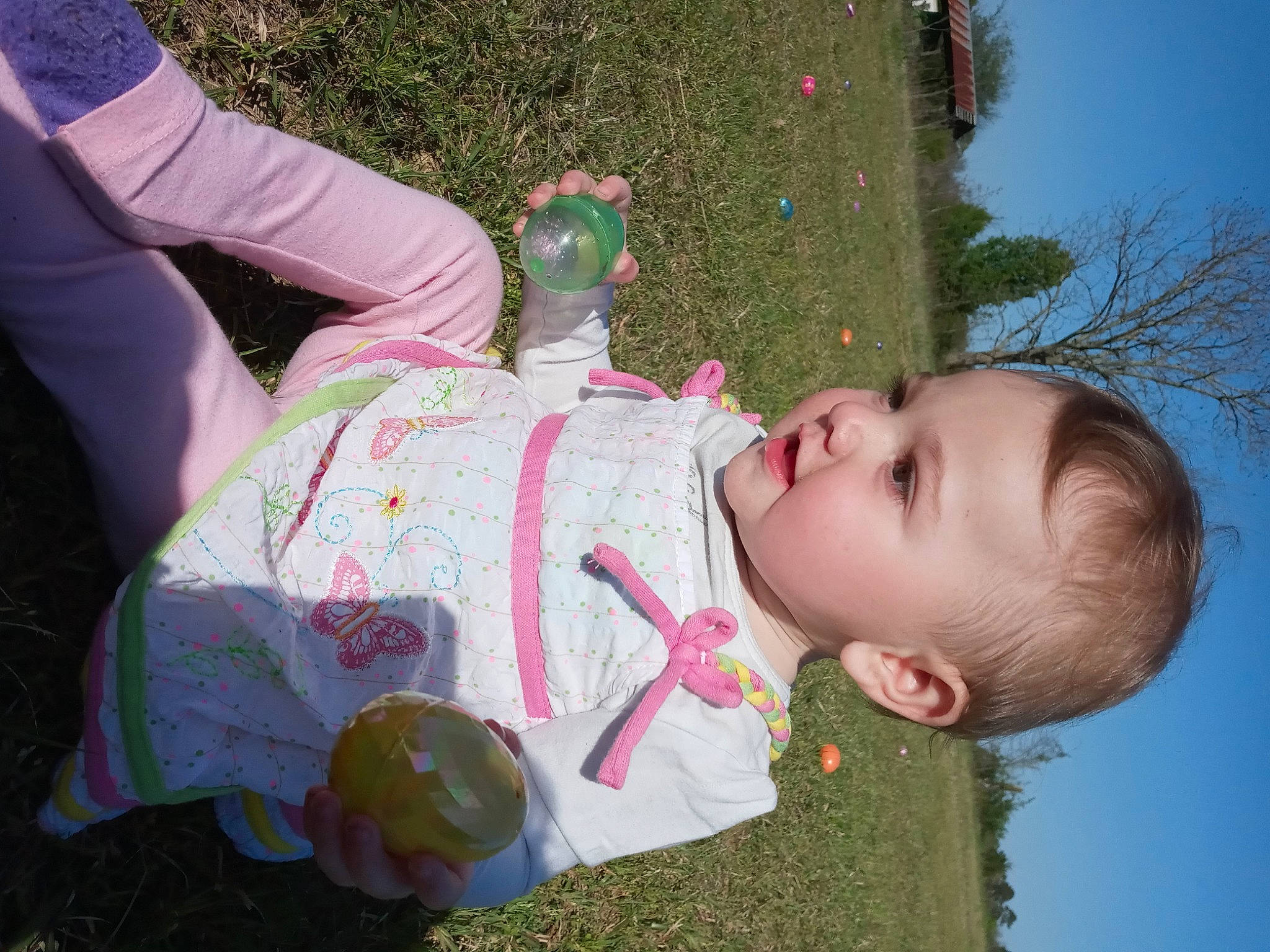Serena Rene is registered to the contest to win money with this photo: baby, baby_toddler_clothing, botany, child, fun, grass, grassland, happy, leaf, leisure, people_in_nature, person, pink, plant, recreation, sitting, sky, spring, toddler, tree