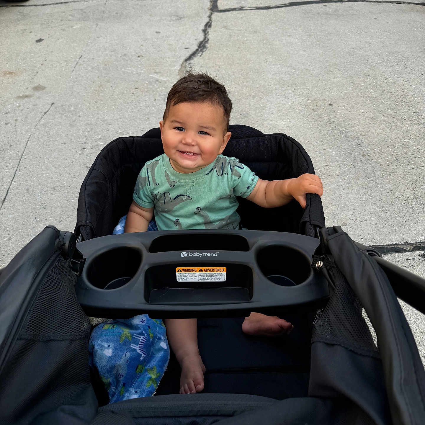 Jaxon is registered to the contest to win money with this photo: accessories, baby, car, city, face, happy, head, machine, person, photography, portrait, road, smile, street, stroller, tire, transportation, urban, vehicle, wheel
