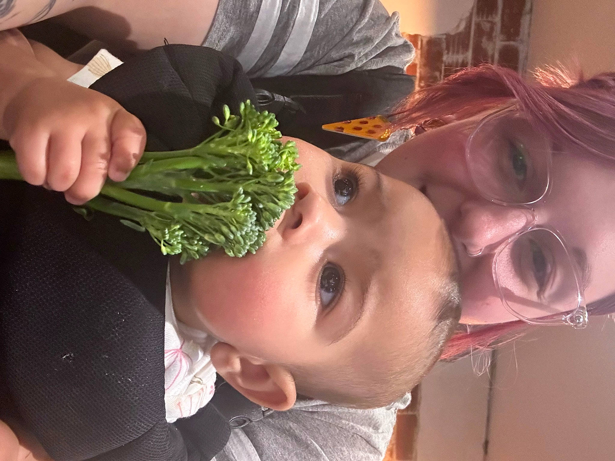 Celeste is registered to the contest to win money with this photo: baby, child, ear, event, eyelash, eyewear, fashion_accessory, flower_arranging, fun, grass, happy, headgear, joy, leaf_vegetable, mouth, nose, person, plant, skin, toddler