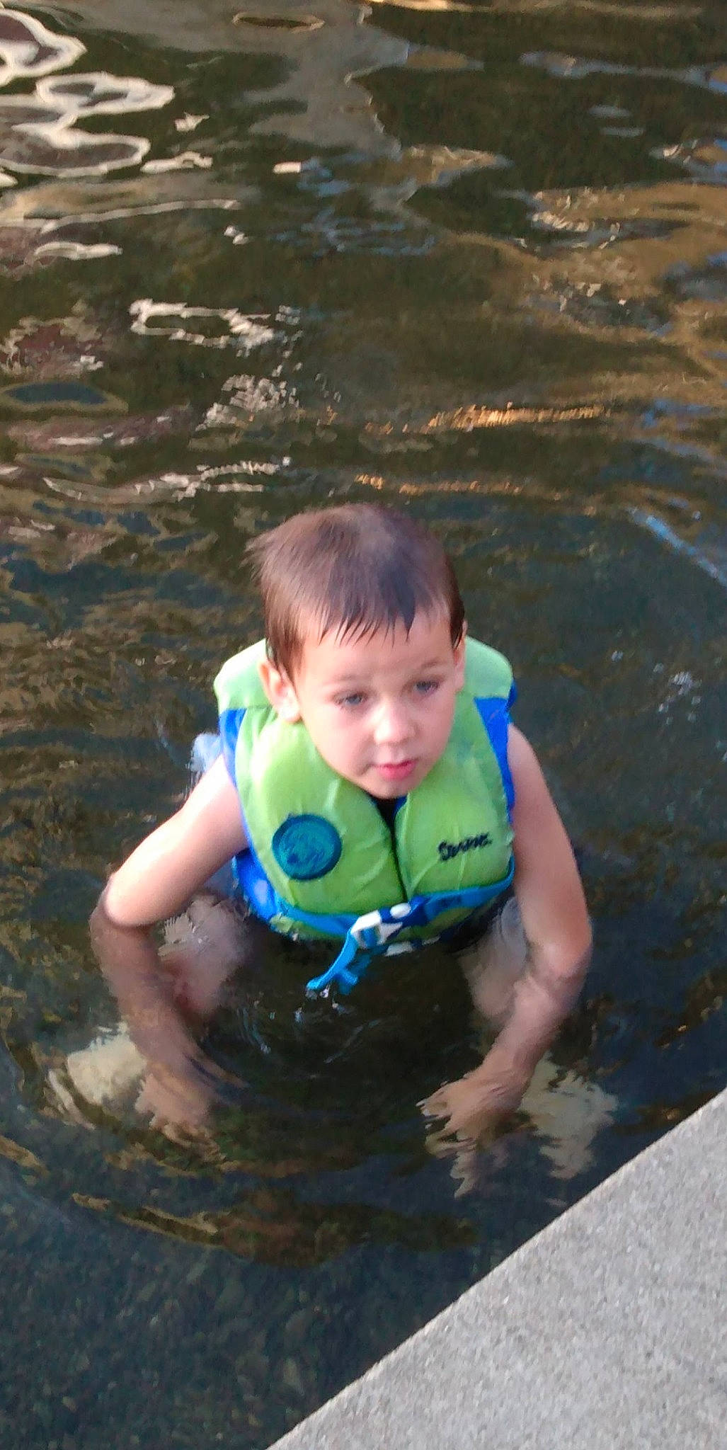 Jaxson is registered to the contest to win money with this photo: baby, baby_toddler_clothing, child, fun, grass, head, lake, leisure, lifejacket, outdoor_recreation, people_in_nature, person, personal_protective_equipment, play, recreation, swimming_pool, toddler, tubing, water, wave