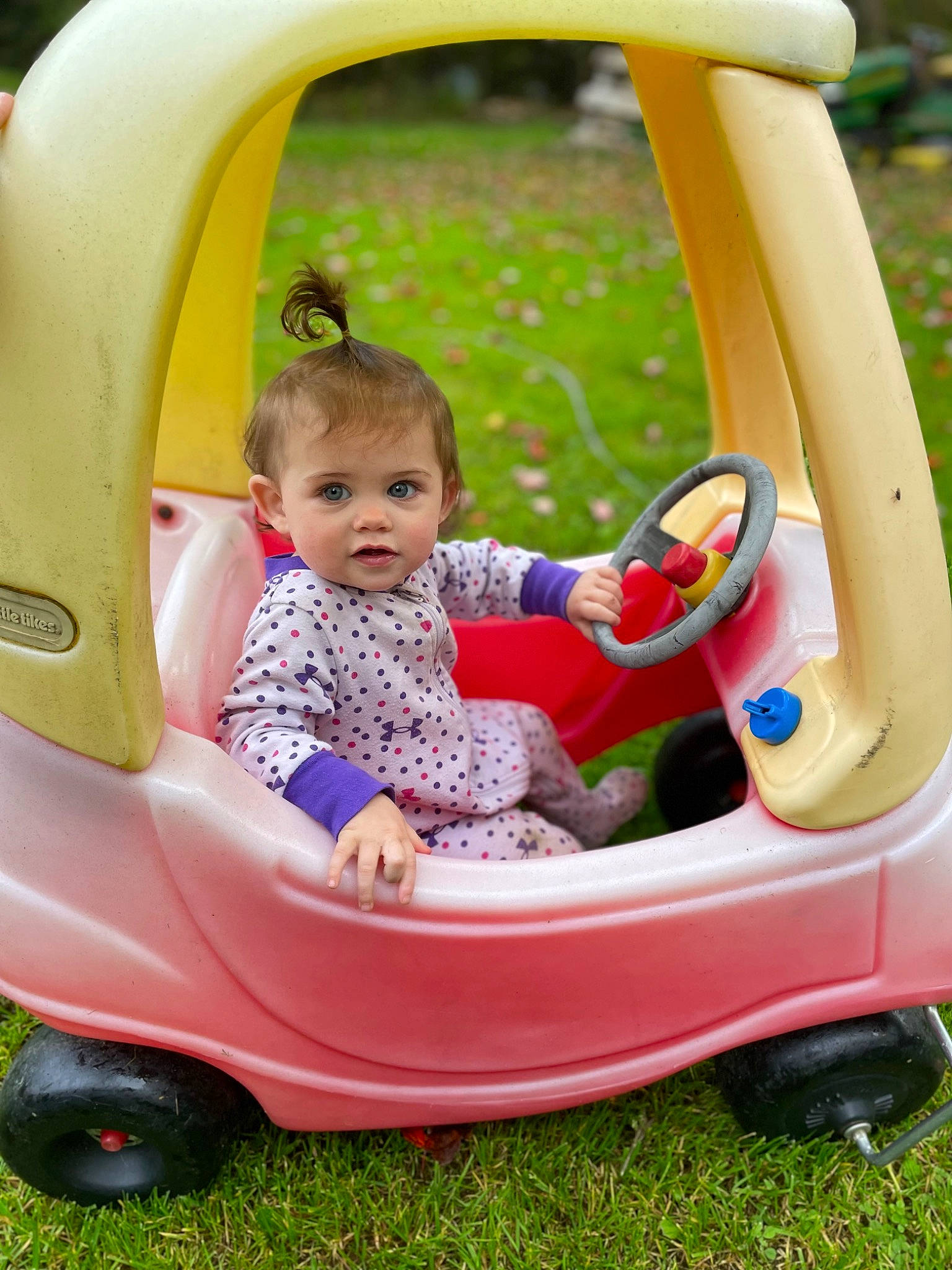 Reign Elizabeth joined the competition — help win amazing prizes! automotive_design, automotive_exterior, baby, baby_toddler_clothing, comfort, facial_expression, fun, grass, green, leisure, motor_vehicle, person, photograph, pink, public_space, recreation, tire, toddler, vehicle, wheel