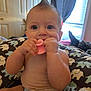 Aria joined the competition — help win amazing prizes! baby, child, indoor, toy, chewing, mohawk, blue_eyes, cushion, elephant_pattern, diaper, curtains, window, furniture, skin, hand, face, person, infant, sitting, room