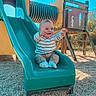baby, blue_sky, child, clothing, cute, daylight, fun, gravel, happy, infant, outdoor, person, play, playground, recreation, sitting, slide, smiling, toy, wood