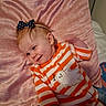 Blakely-Peach joined the competition — help win amazing prizes! baby, bed, bow, cartoon, child, cute, face, ghost, hair_accessory, indoor, infant, lying_down, nursery, orange, pillow, pink, portrait, smiling, striped_clothing, white