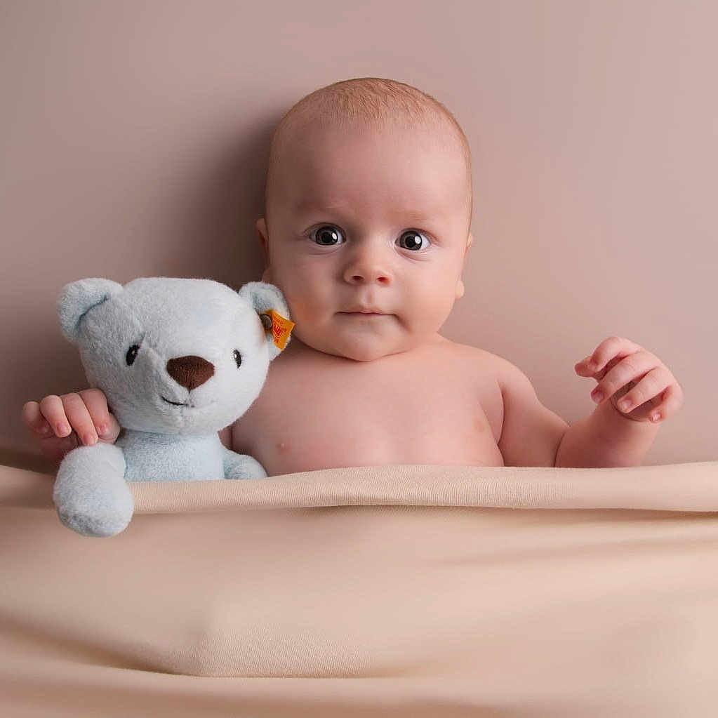Liev joined the competition — help win amazing prizes! baby, bed, blanket, bodypart, face, finger, furniture, hand, happy, head, indoors, newborn, person, photography, plush, portrait, sitting, smile, teddybear, toy