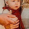 adult, baby, bow, child, closeup, cute, fall, family, hands, headband, holding, knitwear, outdoor, person, portrait, red_clothing, sweater, toddler, warm_lighting, young_child