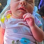 baby, sleeping, infant, onesie, floral_pattern, hand, skin, outdoor, natural_light, peaceful, closeup, portrait, child, newborn, person, soft, background_blur, relaxation, cute, young