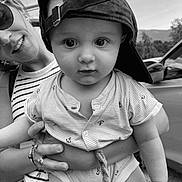 Gaëtan participe au concours pour gagner de l'argent avec cette photo : baby, child, woman, cap, hat, sunglasses, smile, striped_shirt, outdoor, car, holding, face, person, portrait, black_and_white, cute, young_child, nature, rope, hand