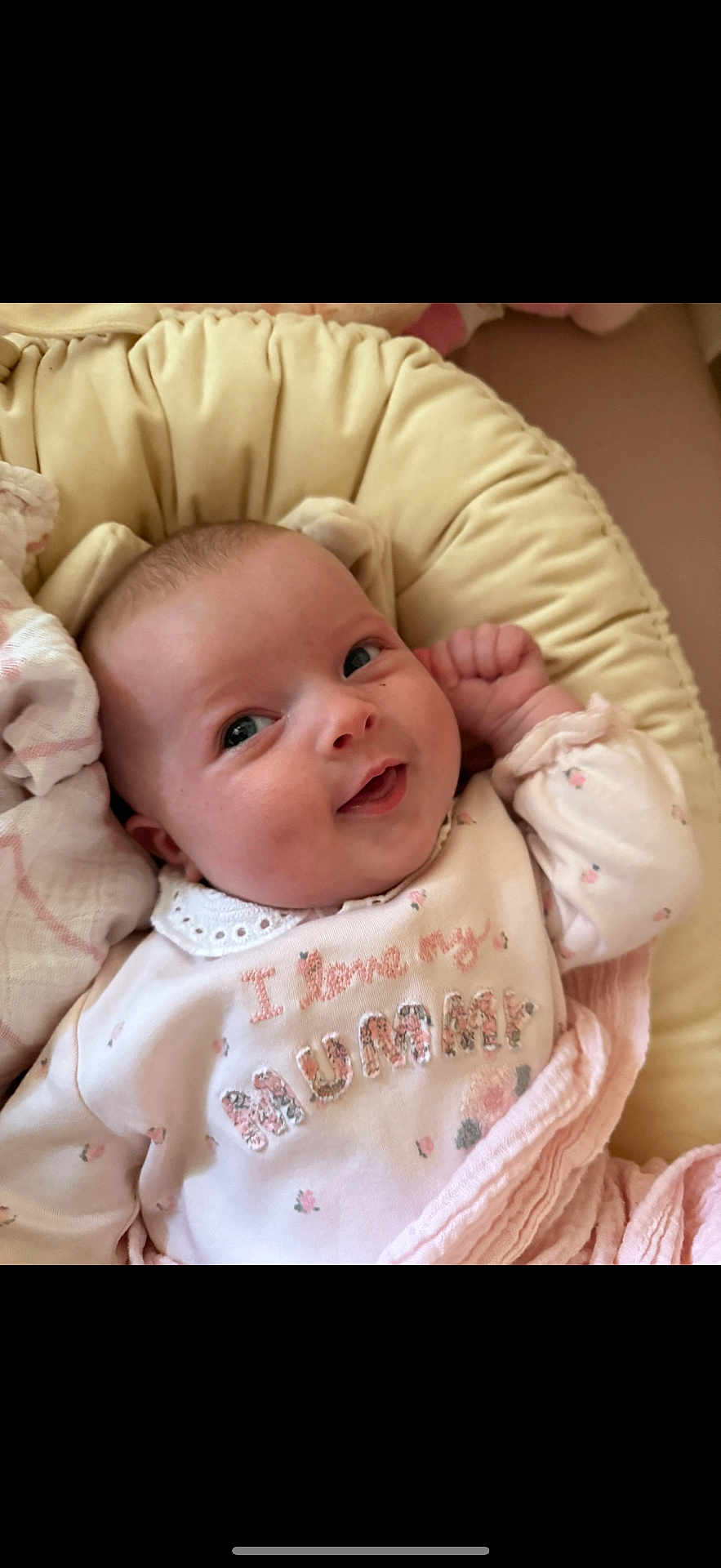Bonnie Rose is registered to the contest to win money with this photo: baby, infant, smiling, face, person, clothing, cushion, soft, cute, child, portrait, indoors, closeup, pink, sleeping_bag, happy, newborn, baby_girl, cozy, blanket