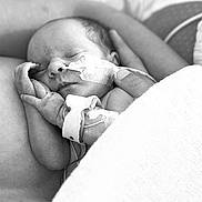 Ella participe au concours pour gagner de l'argent avec cette photo : newborn, baby, sleeping, medical_tube, swaddled, black_and_white, infant, hand, adult_arm, peaceful, hospital, closeup, portrait, tender, resting, fragile, skin, blanket, care, love