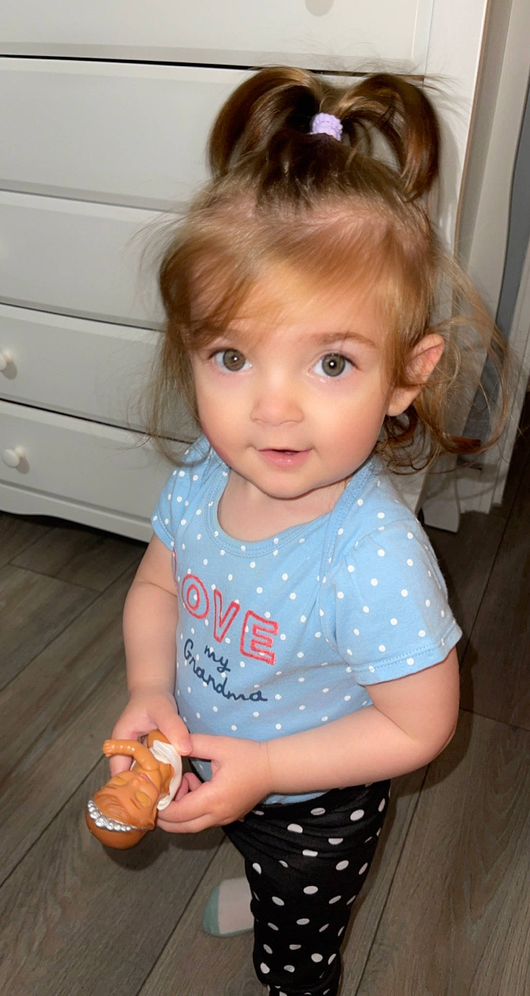 Leandra is registered to the contest to win money with this photo: baby_toddler_clothing, cabinetry, cheek, child, chin, eyelash, face, hair, hairstyle, head, iris, neck, nose, organ, person, shoulder, skin, sleeve, standing, t_shirt