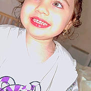 Emma Ridajova is registered to the contest to win money with this photo: child, toddler, smile, face, white_jacket, minnie_mouse, toy, purple, checkered, indoor, curly_hair, happy, cute, portrait, clothing, person, baby, light_skin, earring, flash_photo