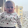 Elena participe au concours pour gagner de l'argent avec cette photo : baby, smiling, child, window, snow, winter, holiday_sweater, candy_cane_pattern, indoor, person, face, joyful, festive, clothing, hand, bright, cheerful, portrait, cute, young