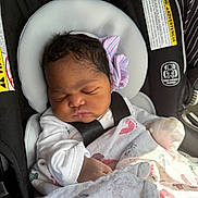 Mercedes joined the competition — help win amazing prizes! baby, blanket, bow, car_seat, child, clothing, cute, face, hands, head, indoors, infant, newborn, peaceful, portrait, safety_harness, sleeping, soft, striped, wrapped
