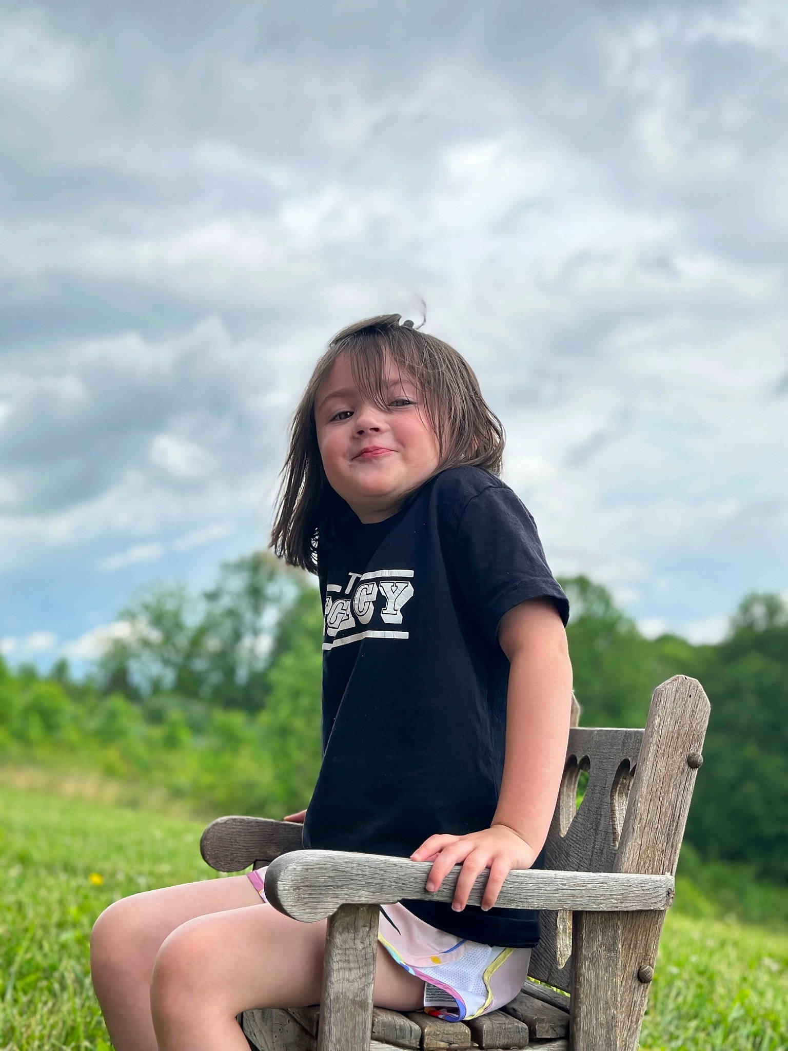 Avery joined the competition — help win amazing prizes! chair, cloud, face, facial_expression, flash_photography, fun, grass, grassland, happy, joy, leisure, people_in_nature, person, recreation, shorts, shoulder, sitting, sky, smile, standing