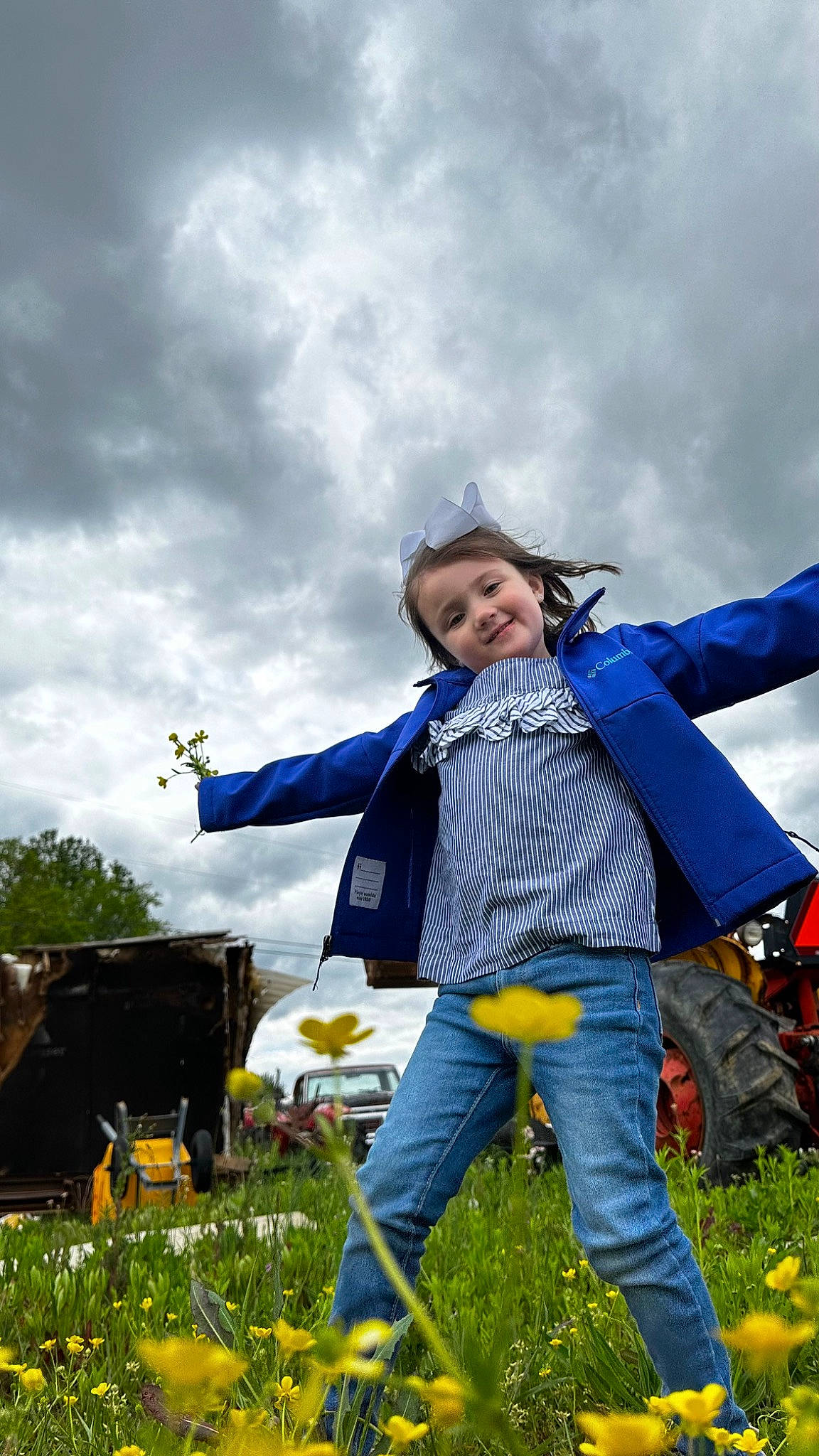 Avery is registered to the contest to win money with this photo: cloud, daytime, electric_blue, flower, fun, grass, grassland, happy, jacket, joy, landscape, lawn, leisure, meadow, people_in_nature, person, plant, recreation, sky, smile