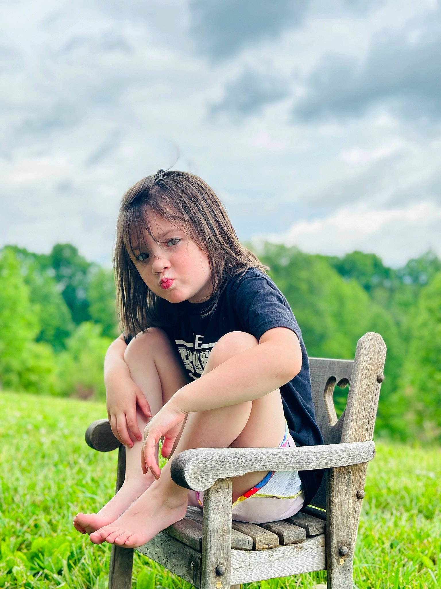 Avery is registered to the contest to win money with this photo: brown_hair, cloud, flash_photography, fun, grass, grassland, happy, human_leg, knee, landscape, leisure, long_hair, outdoor_furniture, people_in_nature, person, plant, recreation, shoe, sitting, sky