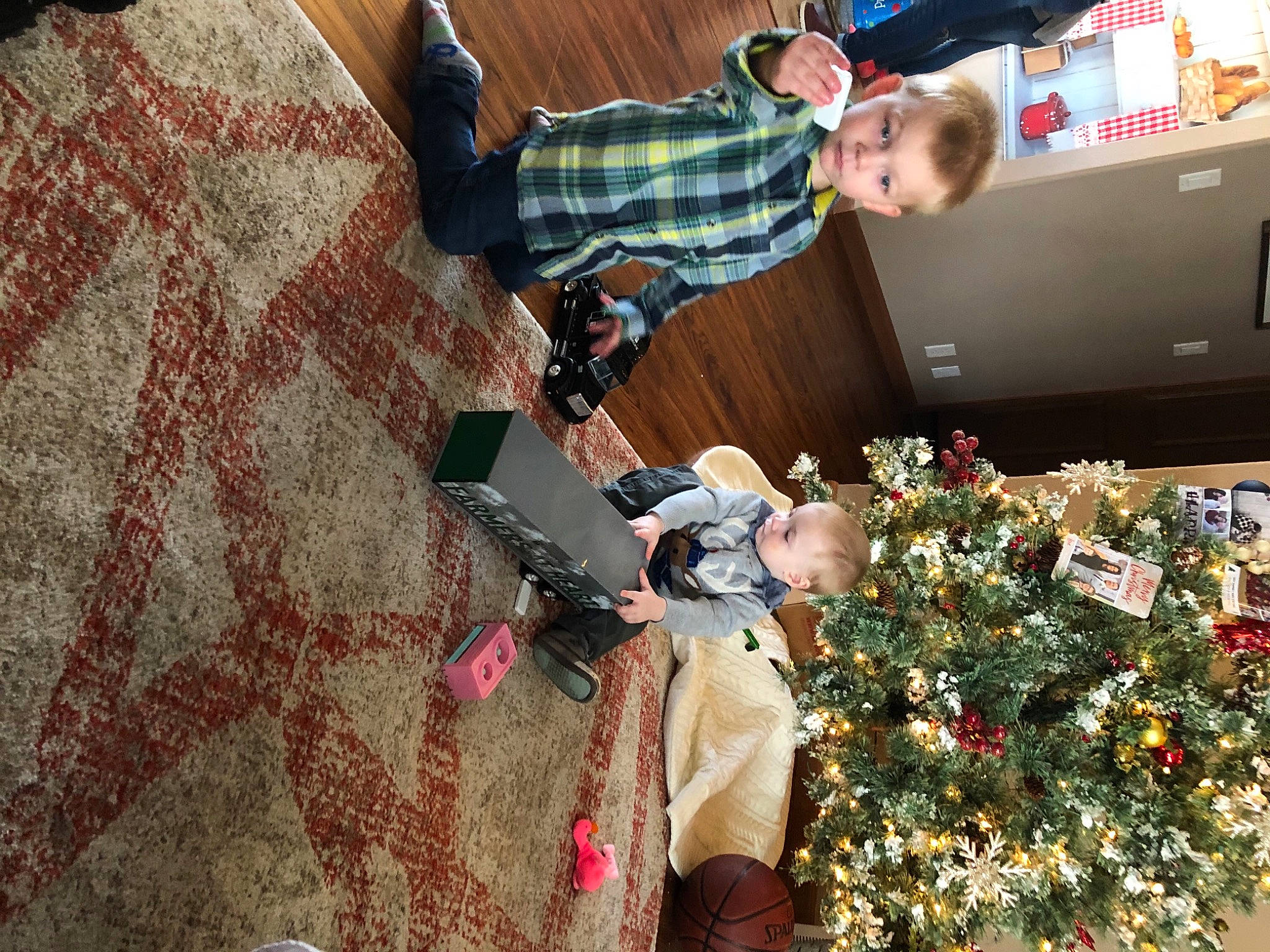 Ryder is registered to the contest to win money with this photo: cable_television, christmas, christmas_decoration, christmas_eve, christmas_ornament, christmas_tree, computer_monitor, conifer, display_device, fir, flat_panel_display, holiday, holiday_ornament, human, lcd_tv, led_backlit_lcd_display, ornament, person, play, television