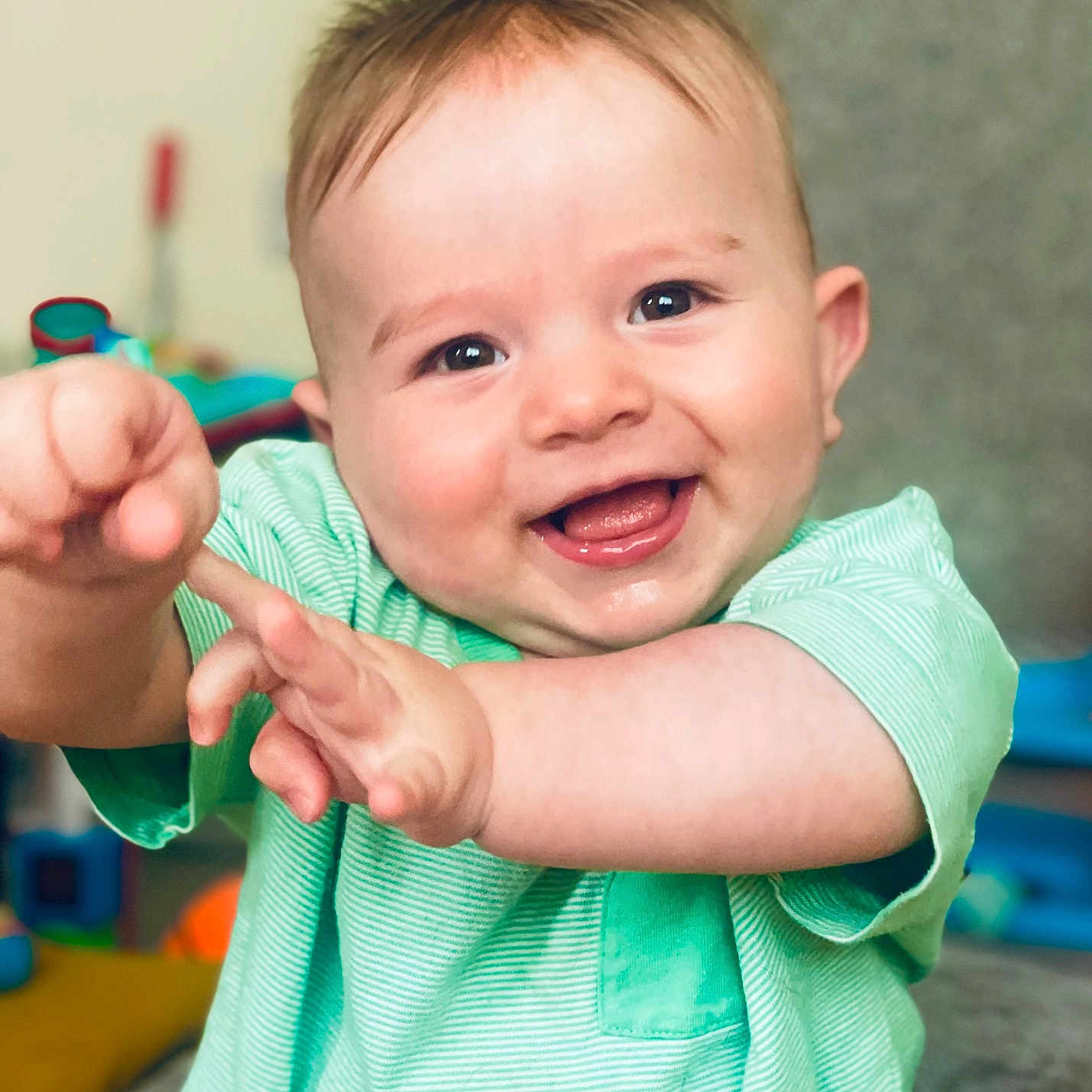 Otis joined the competition — help win amazing prizes! baby, cheerful, child, cute, expression, eyes, face, green_shirt, hair, hands, happy, head, indoor, infant, person, playful, portrait, skin, smiling, young_child