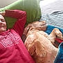 bed, blanket, blue_blanket, casual_clothing, comfort, dog, golden_retriever, green_pillow, home, human, indoor, leisure, man, pet, pillow, red_sweatshirt, relaxing, resting, sleeping_dog, smiling
