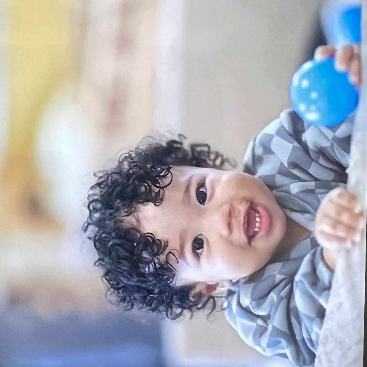 Junaid joined the competition — help win amazing prizes! baby, blue_ball, child, closeup, clothing, curly_hair, cute, expression, face, fun, hands, happy, indoor, leisure, person, playful, portrait, smiling, toddler, young