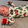 Waylon is registered to the contest to win money with this photo: baby, child, christmas_theme, comfort, cute, expression, face, festive, hand, holiday, indoors, infant, lying_down, newborn, pajamas, person, relaxed, skin, sleepwear, soft_surface