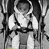 Raayan a rejoint le concours — aidez-le/la à gagner de superbes lots ! baby, stroller, infant, pacifier, clothing, hood, blanket, sitting, child, face, cute, outdoor, black_and_white, feet, hands, straps, quilted, jacket, milestone, text_overlay