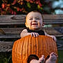 baby, pumpkin, bench, autumn, fall, carved_pumpkin, child, smiling, outdoor, feet, cute, holiday, seasonal, nature, wood, person, celebration, fun, holiday_costume, orange