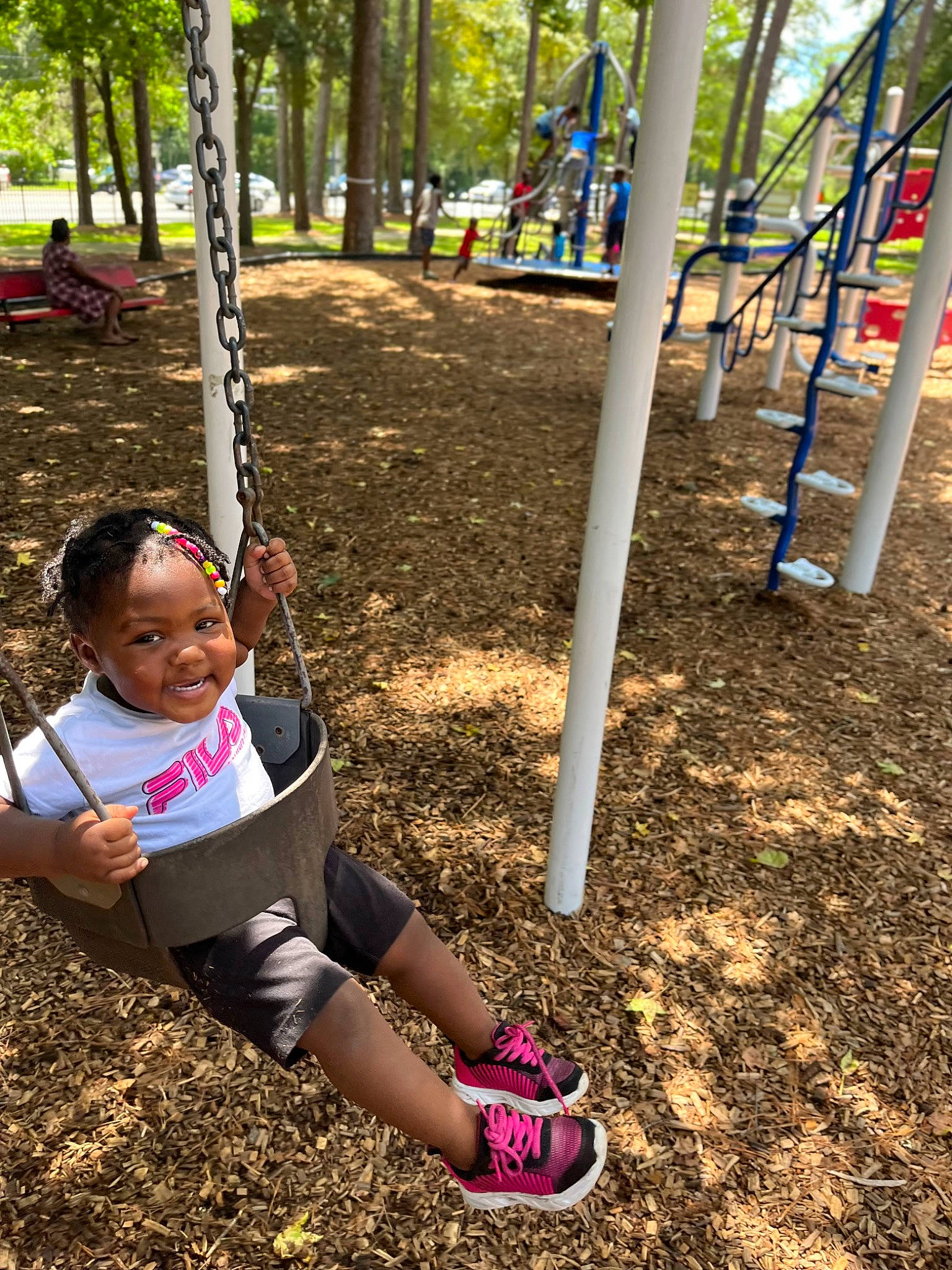 Zaleah is registered to the contest to win money with this photo: child, city, fun, grass, happy, joy, knee, leisure, outdoor_play_equipment, outdoor_recreation, people_in_nature, person, plant, play, playground, public_space, recreation, smile, swing, thigh
