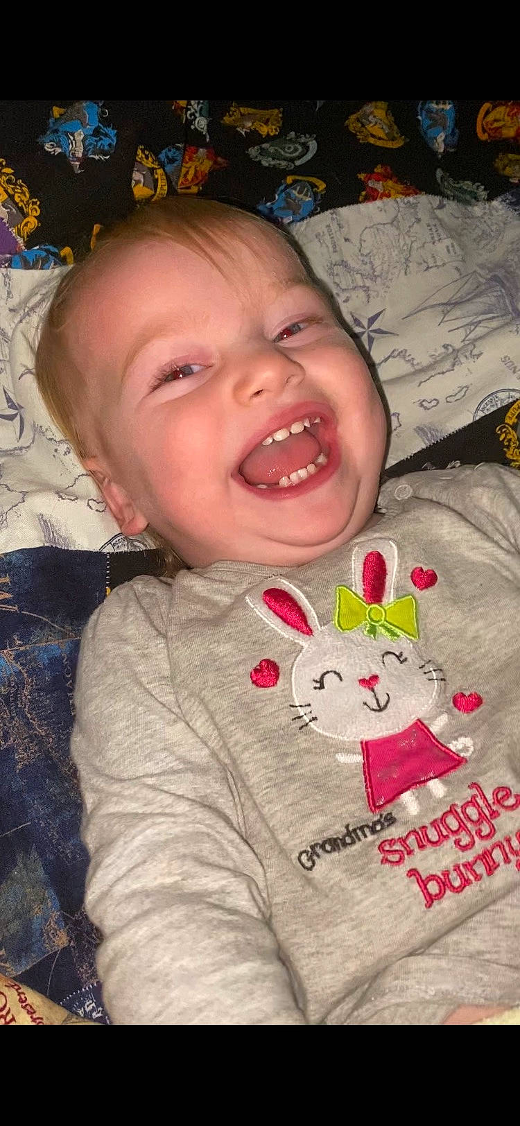 Alice is registered to the contest to win money with this photo: baby, baby_laughing, baby_toddler_clothing, cheek, child, facial_expression, happy, head, iris, linens, lip, mammal, nose, organ, person, pink, product, skin, sleeve, smile