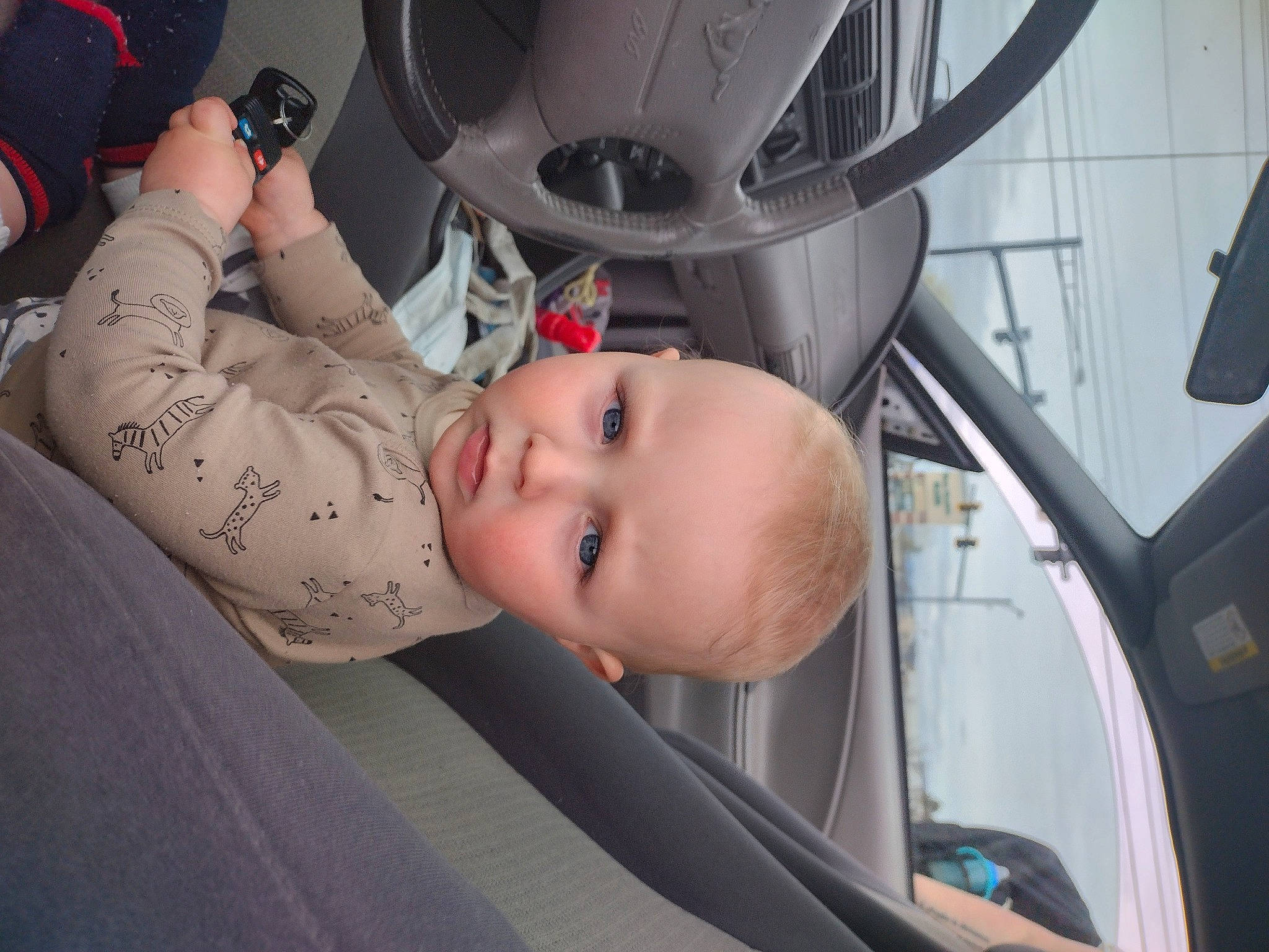 Bailey is registered to the contest to win money with this photo: auto_part, automotive_design, automotive_exterior, automotive_lighting, automotive_tire, automotive_wheel_system, baby, bumper, child, comfort, finger, fun, motor_vehicle, person, rim, skin, tire, toddler, vehicle, vehicle_door